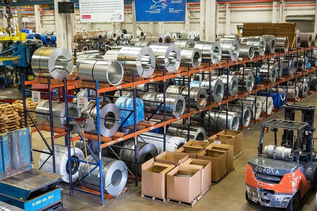 Modern warehouse with forklifts and equipment being inspected using ForkliftTracker digital inspection app